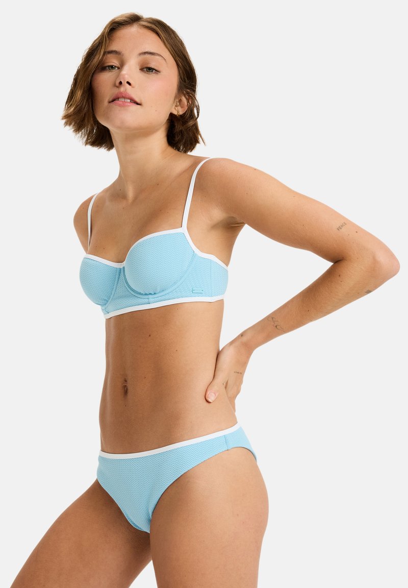 Blue bikini set with textured fabric, featuring a fitted top and low-rise bottom, both outlined in white. Adjustable thin straps.