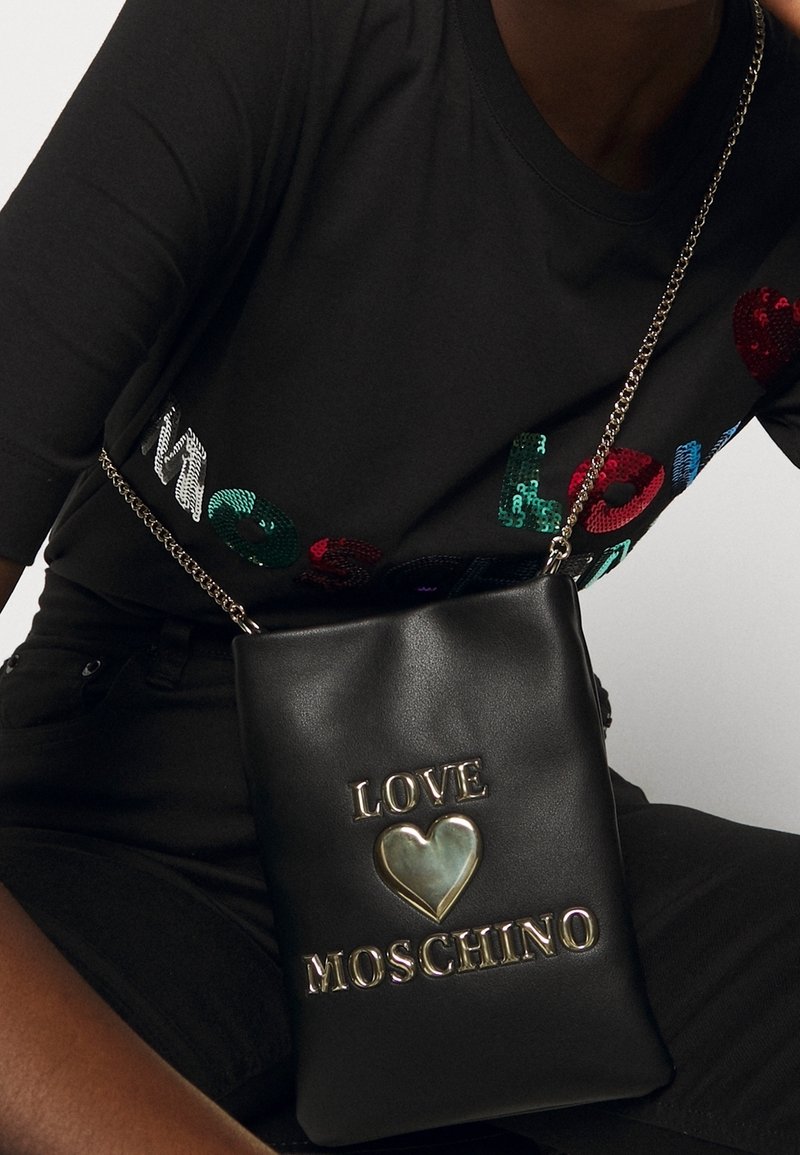Black faux leather crossbody bag with a silver chain strap. Features embossed "LOVE" and heart logo, along with "MOSCHINO" lettering.
