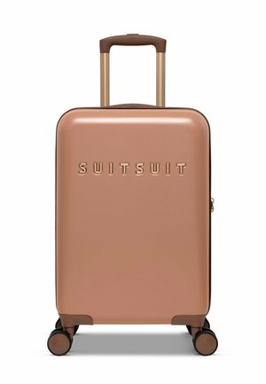 Hard-shell suitcase in rose gold with a smooth finish, featuring a gold logo, extendable handle, and four multi-directional wheels.