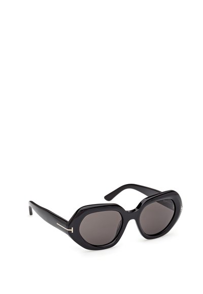 Occhiali da sole neri con montatura esagonale sovradimensionata, lenti scure e una finitura lucida e elegante. Presentano un accento dorato sulla tempia.