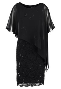 Svart klänning med ett genomskinligt överdrag. Kroppen har en spetsdesign med paljetter, medan ärmarna är flödande och något oregelbundna.