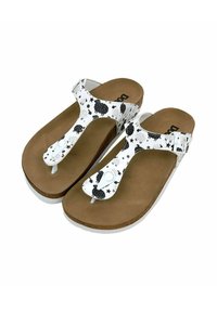 White sandals with black patterns featuring trees and stars. Cork-like sole, adjustable strap, and a toe post design. Smooth texture.