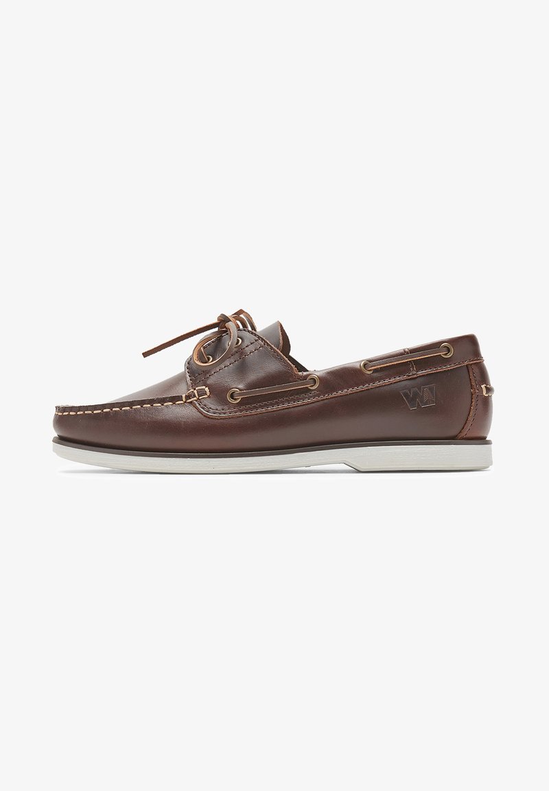 Brown leather boat shoe with a white rubber sole, leather laces, and metal eyelets; features stitching along the edges and a logo detail.