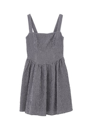 Vestido de cuadros en blanco y negro con tirantes ajustables, corsé entallado y falda acampanada. Hecho de un tejido ligero con un acabado texturizado.