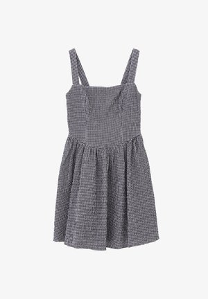 Vestido de cuadros en blanco y negro con tirantes ajustables, corsé entallado y falda acampanada. Hecho de un tejido ligero con un acabado texturizado.