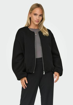 Veste bomber noire avec un col rond, fermeture éclair à l'avant et manches volumineuses. Tissu lisse avec une coupe décontractée.