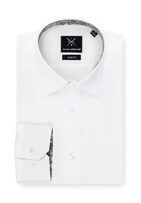 Biała, dopasowana koszula o slim fit z wzorzystym wnętrzem kołnierza i mankietów. Posiada klasyczne guziki oraz gładką teksturę. Metka widoczna przy dekolcie.