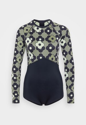 Long-sleeve swimsuit featuring a floral pattern in green and navy, with a solid navy bottom, smooth texture, and sporty design.