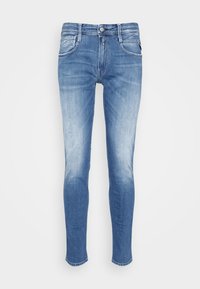 Blue skinny jeans with faded wash detailing, front button closure, and five-pocket design displayed on a white background.