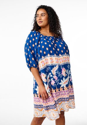 Vestido azul con flores y mangas abullonadas, con un dobladillo estampado en rosa, naranja y blanco. Fabricado en una tela ligera con un corte relajado.