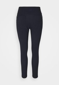Leggings negros con cintura alta, hechos de un material elástico. Presenta dos bolsillos traseros con cremallera y una textura suave y elegante.