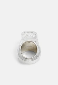 Crystal ring with an octagonal shape, clear material, textured surface, and a silver inner band, size 58.