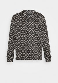 Chemise noire à manches longues avec un motif cachemire en crème et gris. Tissu lisse, design sans col et fermeture à boutons sur le devant.