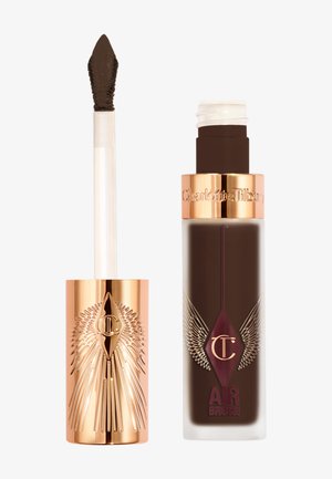 Braune flüssige Foundation in einer klaren Glasflasche mit einem goldenen Verschluss. Enthält einen Applikator mit spitz zulaufender Spitze und einem strukturierten Design.