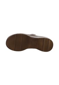 Brown rubber shoe sole with horizontal grooves and ridges. Features embossed logo on the heel area, textured surface for grip.