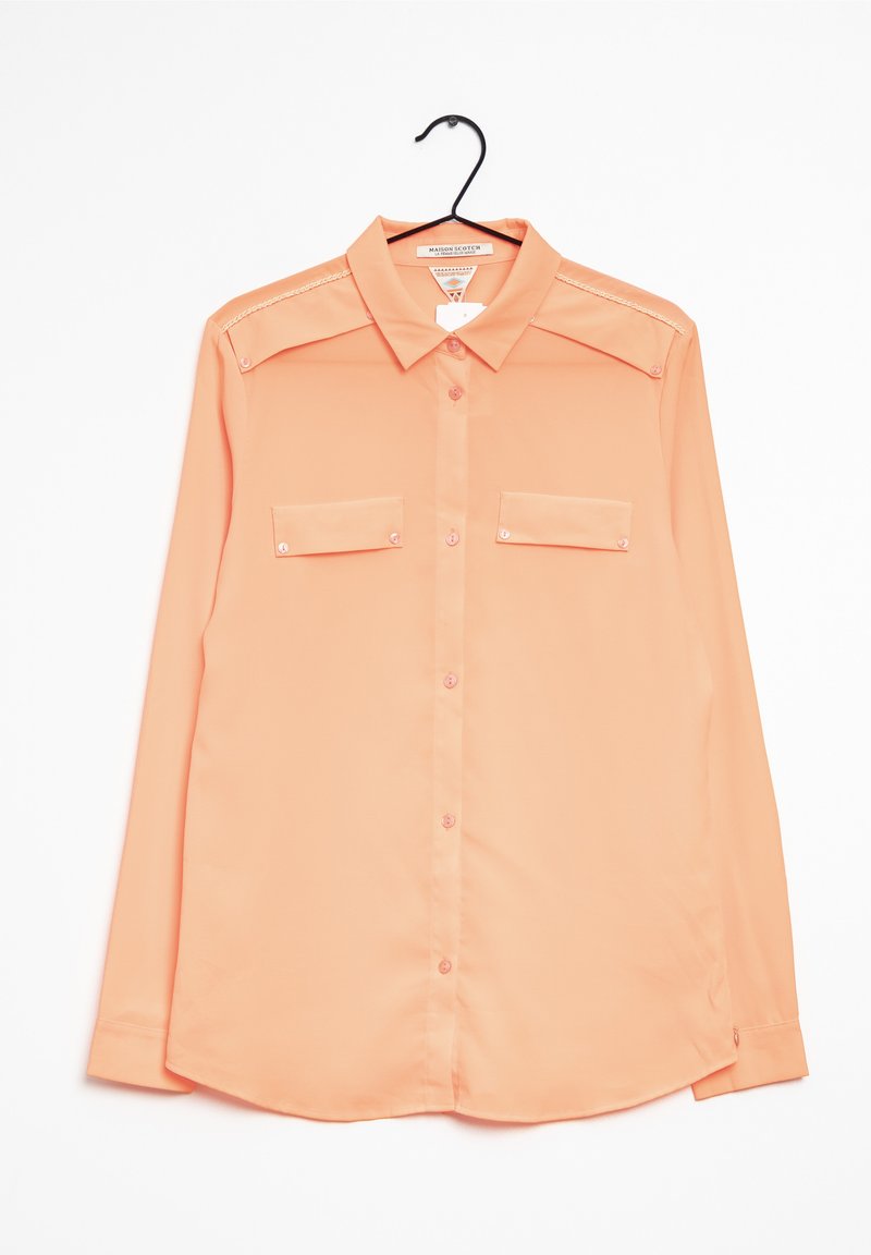 Light peach long-sleeve button-up shirt with two front pockets, collar, and shoulder embellishments; made of smooth fabric.