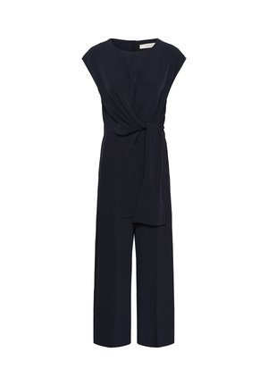 Mornarska kombinezonska haljina s kratkim rukavima, vezivanjem oko struka i širokim nogavicama. Izrađena od glatkog materijala s skrivenim patentnim zatvaračem na leđima.