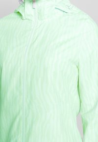 Light green zip-up jacket made from smooth, lightweight material featuring subtle striped patterns and a hood for added coverage.