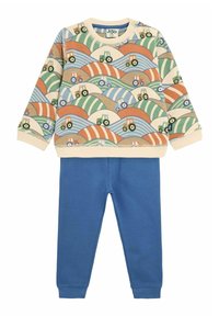 Baumwoll-Sweatshirt mit buntem Traktor-Druck auf cremefarbenem Grund. Kombiniert mit blauen Baumwoll-Jogginghosen. Mit gerippten Bündchen und Taillenbund.