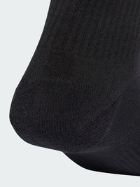 Calza nera con una consistenza a coste e una finitura liscia. Il materiale sembra tessuto, con una punta senza cuciture per il massimo comfort.