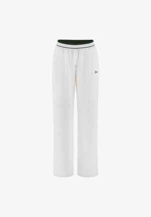 Weiße Jogginghose aus strukturiertem Material, mit einem grünen gerippten Bund mit weißen Streifen und einem kleinen Logo auf der Vorderseite.