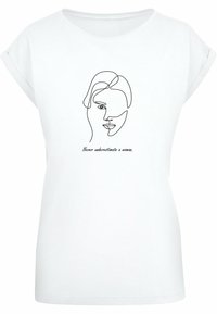 Hvid bomulds t-shirt med opfoldede ærmer, med et minimalistisk sort linjetegning af et ansigt og teksten "Underestimér aldrig en kvinde."
