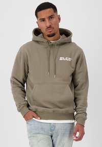 Olive green hoodie made of soft fabric, featuring a front pocket, adjustable drawstring hood, and white logo text on the chest.