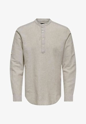 Light beige long-sleeve shirt made of linen with a round neckline, button placket, and rounded hem; features subtle texture.