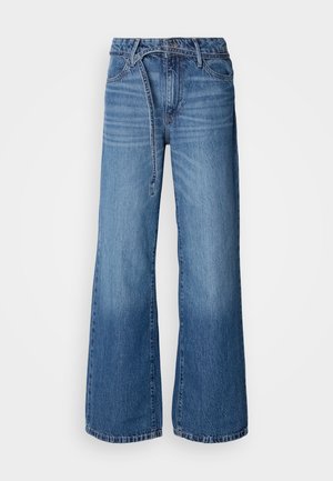 Light blue wide-leg jeans made of denim. Features a high waist, visible stitching, and a tie belt. Faded texture towards the bottom.