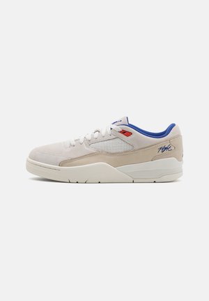 White and beige sneaker with blue inner lining, red eyelet, mesh side panel, and "Flight" text on heel, shown from the side on a white background.