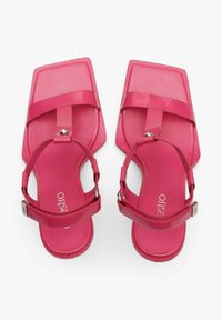 Roze plastic sandalen met een vierkante neus, transparante banden en verstelbare enkelbandjes. Voorzien van een platte zool en een minimalistisch ontwerp.