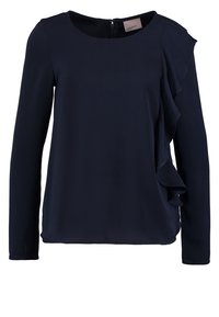 Blusa lunga blu navale con scollo rotondo, caratterizzata da un dettaglio arricciato sul lato sinistro, texture morbida e una discreta cerniera sulla schiena.