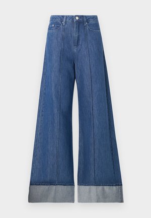 Wide-leg jeans in medium blue denim, featuring a high waist, two front pockets, and a contrasting lighter denim cuff at the hem.