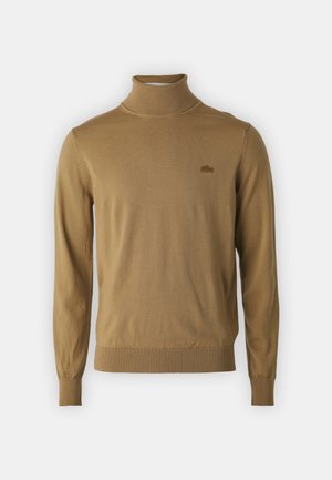 Maglione a collo alto in un caldo colore beige, realizzato in morbido materiale a maglia. Presenta una vestibilità slim e polsini e orlo a coste, con accento del logo.