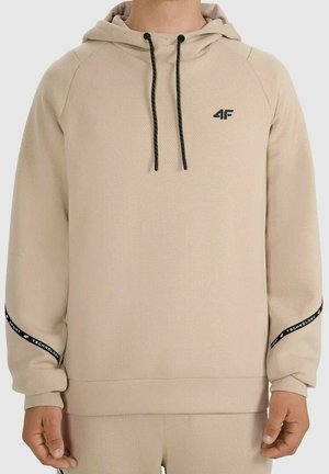 Beżowa bluza z kapturem z czarnymi sznurkami, małe czarne logo "4F" na piersi oraz czarny napis "Sport 4F Technology" na opaskach na rękawach.