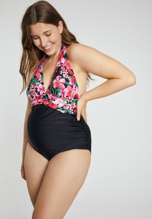 Maillot de bain fleuri avec un décolleté plongeant et un col halter, orné de fleurs roses et vertes sur fond noir, côtés froncés et tissu lisse.