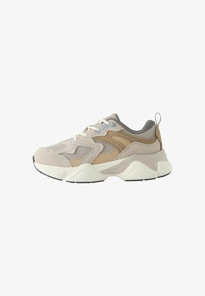 Light beige sneakers with suede and mesh materials, featuring a textured design, neutral accents, and a thick, white sole with black details.