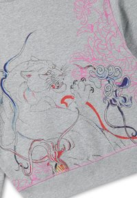 Grey fabric with a detailed embroidered tiger pawing at stylized pink and blue floral designs, accented with red and purple lines.