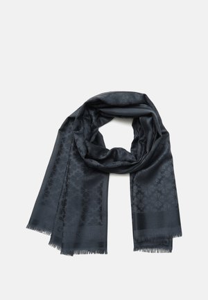 Écharpe gris foncé avec un motif floral subtil et des bords à franges, pliée en boucle lâche sur un fond blanc.