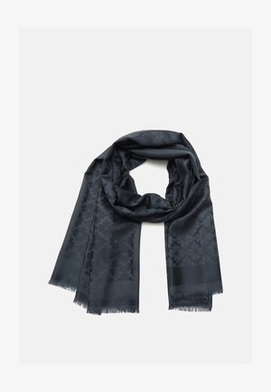 Bufanda gris oscuro con un sutil patrón floral y bordes con flecos, doblada en un lazo suelto sobre un fondo blanco.