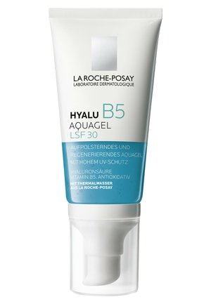 Weißes Röhrchen mit blauer Basis, ausgestattet mit einem Pumpen dispenser. Der Text umfasst "HYALU B5 AQUAGEL LSF 30". Enthält Informationen zu Hydratation und UV-Schutz.