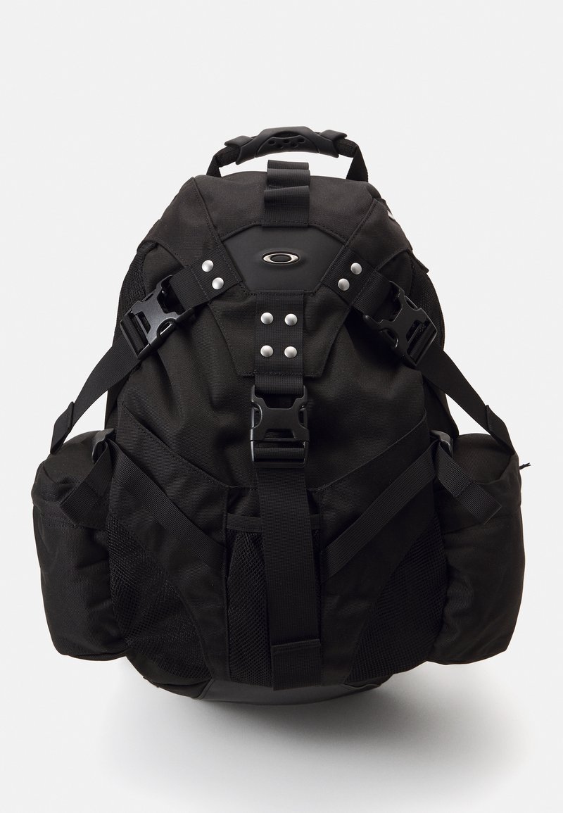 Black outdoor backpack with padded straps, multiple pockets, and metal accents. Features a durable fabric and mesh side pockets.