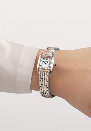 Silberne und vergoldete Metalluhr mit quadratischem Zifferblatt, weißem Ziffernblatt, schwarzen römischen Ziffern und einem geflochtenen Armbanddesign.