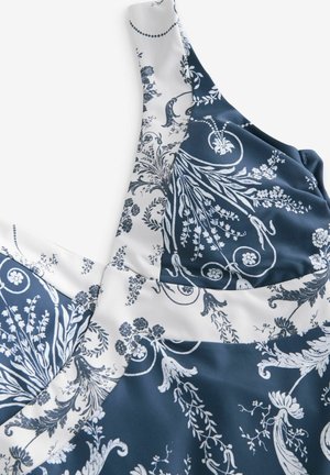 Navy and white dress featuring a floral pattern in a smooth fabric. The design includes intricate detailing and varying textures.