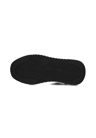 Black rubber sole featuring a zigzag tread pattern, textured surface, and a subtly raised brand name in the center.
