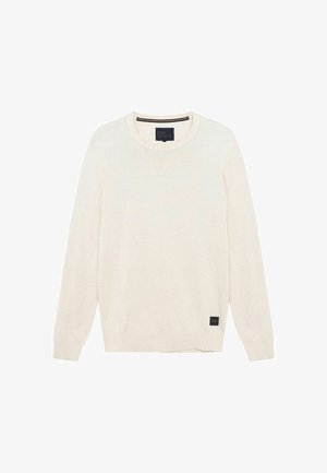Cremefarbener Langarmpullover mit Rundhalsausschnitt, mit gerippten Bündchen und Saum, versehen mit einem kleinen dunklen Etikett nahe dem unteren Rand.