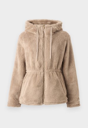 Tan faux fur hooded jacket with a zip closure, drawstring, elastic waist, and two front pockets. Soft texture and relaxed fit design.