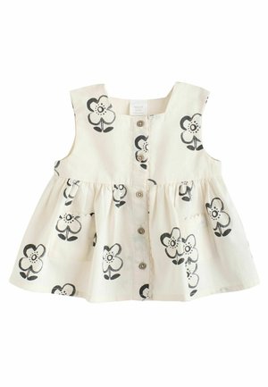 Ärmelloses Kinderdress aus weichem beigen Stoff, mit schwarzen Blumenmotiven, Knöpfen vorne und zwei vorderen Taschen mit Rüschendetails.