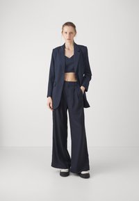 BLANCHE LION PANTS - Nadrágok - rinse