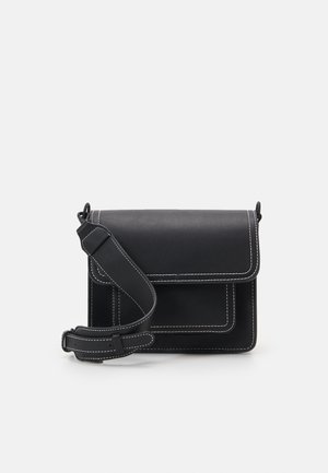 Black leather crossbody bag with white stitching, flap closure, adjustable wide strap, and rectangular front pocket.